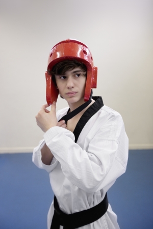 Teenage boy wearing martial arts headgear while looking awayの写真素材