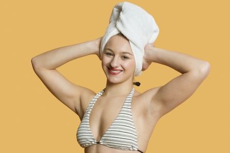 Portrait of a beautiful woman with towel on headの写真素材