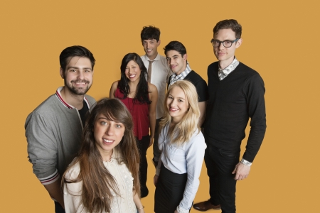 Portrait of group of friends standing together over colored backgroundの写真素材
