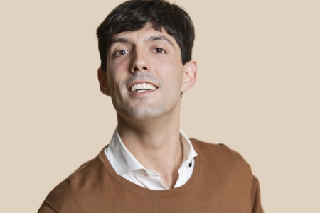 Portrait of a happy young man over colored background
