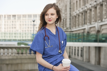 Beautiful young female doctor on a work breakの写真素材