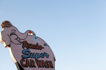 Car wash sign board over clear skyの写真素材