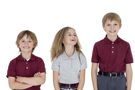 Portrait of cheerful school children in uniform over white background