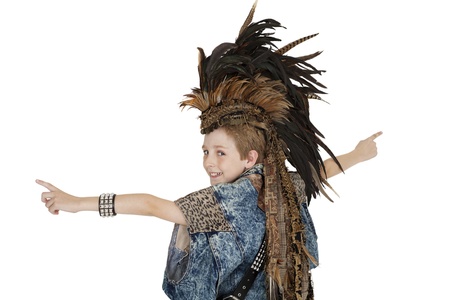 Portrait of boy in costume with headdress looking back over white background