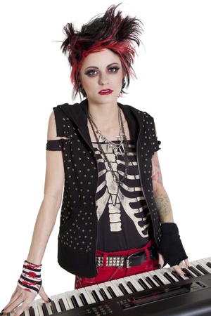 Portrait of rock woman with spiked hair and piano over white backgroundの写真素材