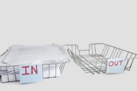 In and out desk trays in an office over white backgroundの写真素材