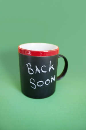 Coffee mug with text over colored backgroundの写真素材