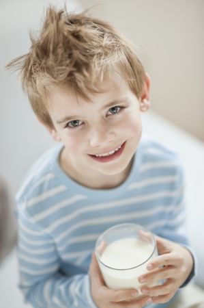 Portrait of happy young boy drinking milkの写真素材