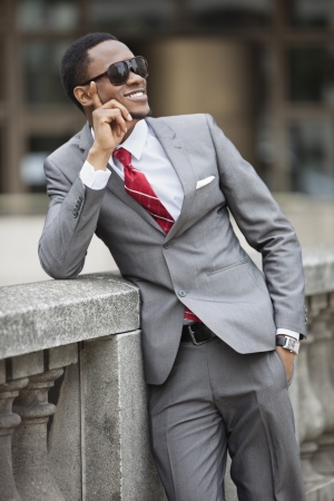 Happy young African American businessman wearing sunglassesの写真素材