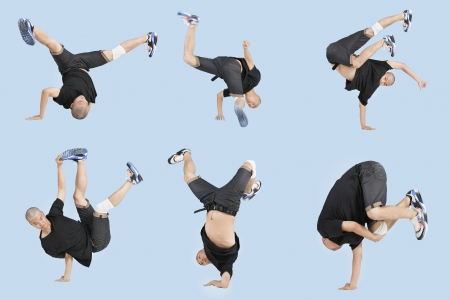 Multiple image of young man break dancing over light blue backgroundの写真素材