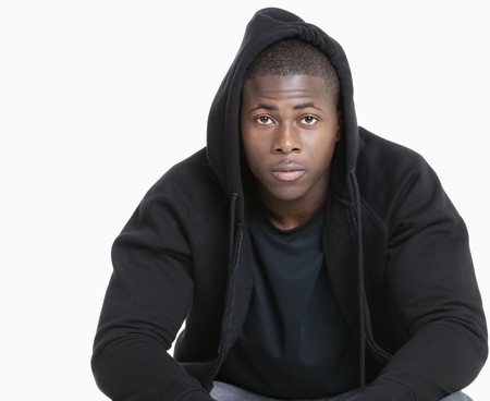 Portrait of a trendy African American man wearing hooded sweatshirt over gray backgroundの写真素材
