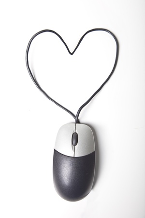 Heart shape made up of computer mouse wire over white backgroundの写真素材