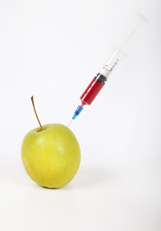 Granny smith apple being injected over white backgroundの写真素材