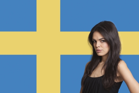 Portrait of young woman against Swedish flagの写真素材
