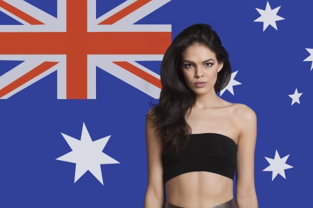 Portrait of young woman in tube bra against Australian flagの写真素材