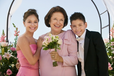 Bride with mother and brother outdoors (portrait)の写真素材