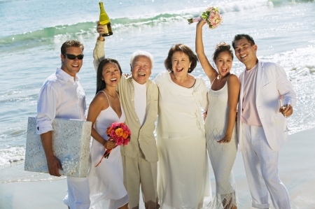 Family celebrating wedding on beachの写真素材
