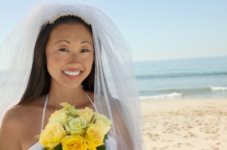 Bride with bouquet on beach (close-up) (portrait)の写真素材