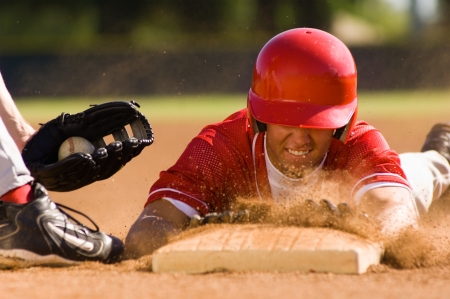 Baseball player sliding into baseの写真素材