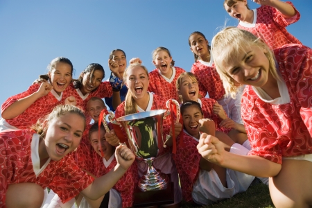 Girls' soccer team (13-17) holding trophyの写真素材