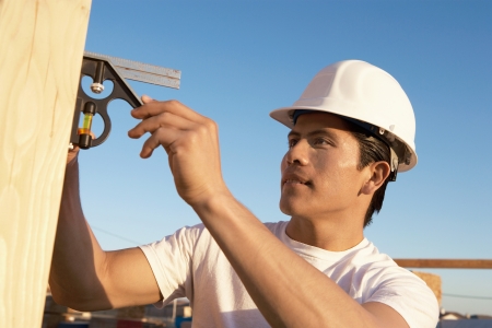 Construction Worker in Hard Hat Building Houseの写真素材