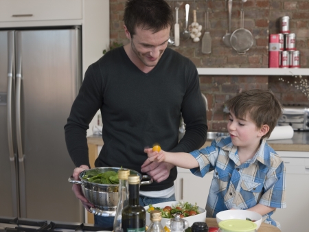 Father and Son Preparing Saladの写真素材