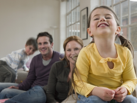 Little Girl Smiling With Familyの写真素材