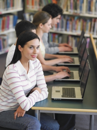Students using laptops in library elevated viewの写真素材