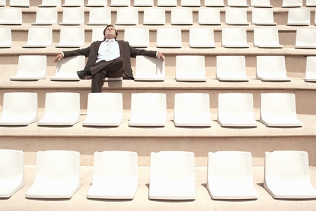 Businessman Relaxing in Auditorium front view.