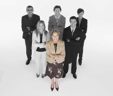 Ambitious businesswoman with team of professionals against white backgroundの写真素材