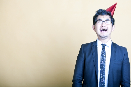 Asian business man wearing party hatの写真素材