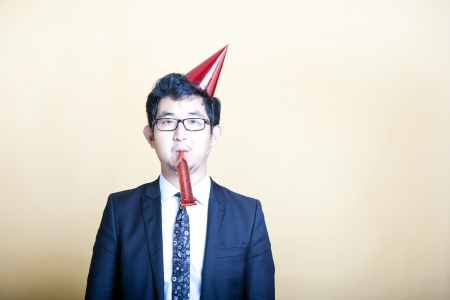 Asian business man wearing party hatの写真素材