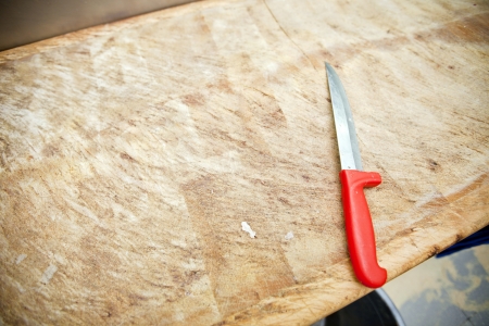 Kitchen knife on wooden cutting board in store