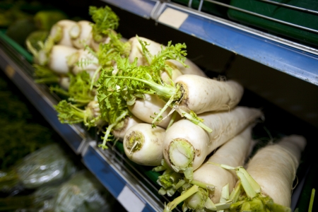 Close-up of radishes on shelf in supermarketの写真素材