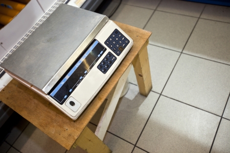 High angle view of weighing machine on stool in supermarketの写真素材