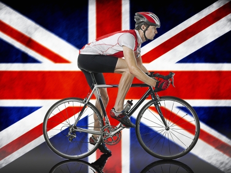 Male Cyclist cycling in front of Union Jack Flagの写真素材