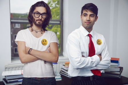 Two men in an office folding their arms