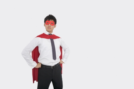 Confident Asian businessman in superhero costumeの写真素材