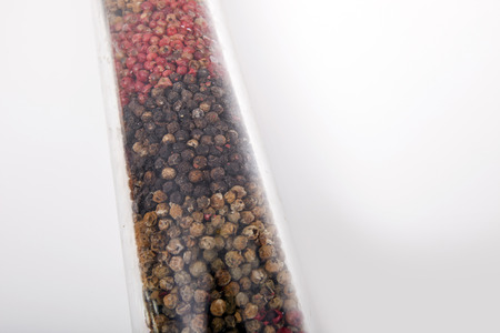 Various peppercorns in package against white backgroundの写真素材