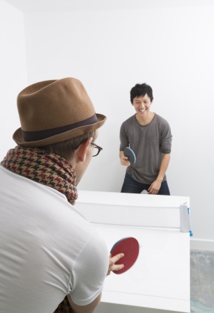 Multiethnic friends playing table tennisの写真素材