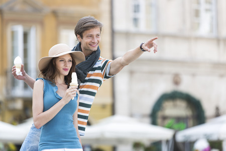 Young couple enjoying ice cream cones during vacationの写真素材