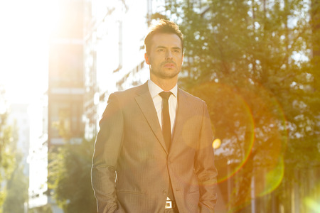Thoughtful businessman looking away outdoorsの写真素材