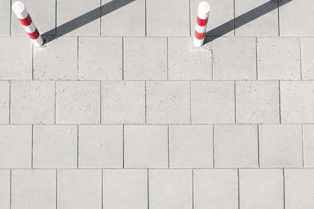 High angle view of striped poles on sidewalk