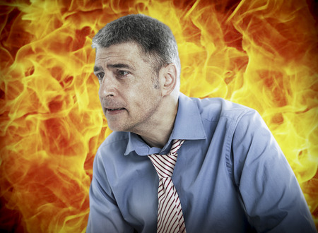 Stressed businessman in shirt and tie against black backgroundの写真素材