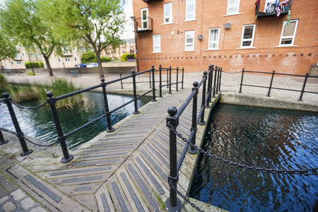 Bridge over canal against buildingの写真素材