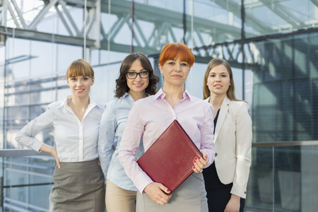 Portrait of confident businesswomen standing together in officeの写真素材
