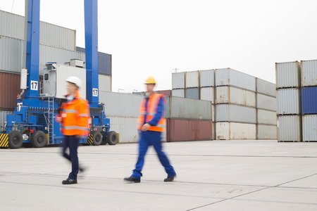 Full-length of workers walking in shipping yard