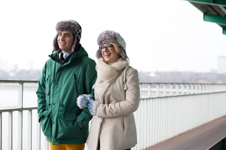 Happy couple walking on footpath during winter