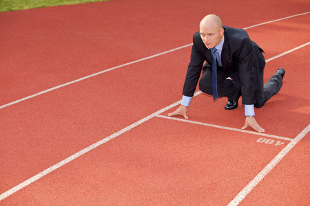 Businessman at the start line of running trackの写真素材