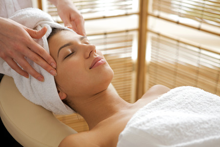 Young woman receiving energy therapy, eyes closedの写真素材